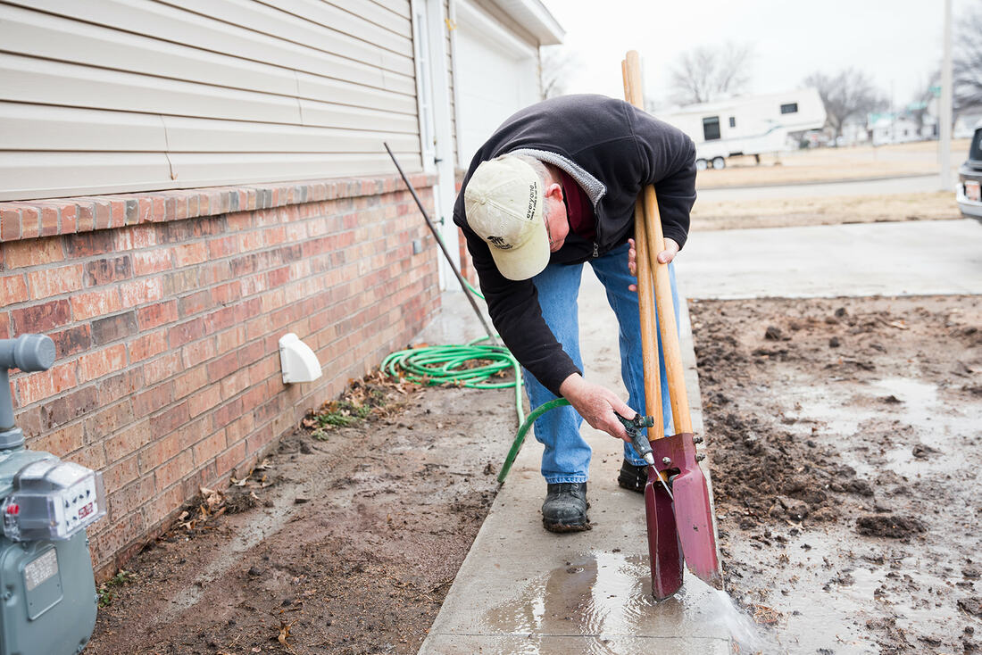 A Habitat volunteer framing a wall on a Ponca City build site